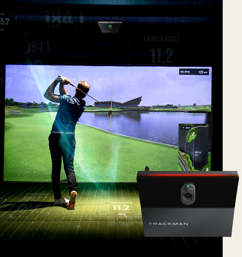 Man swinging a golf club into a golf simulator. Trackman iO product in bottom left.